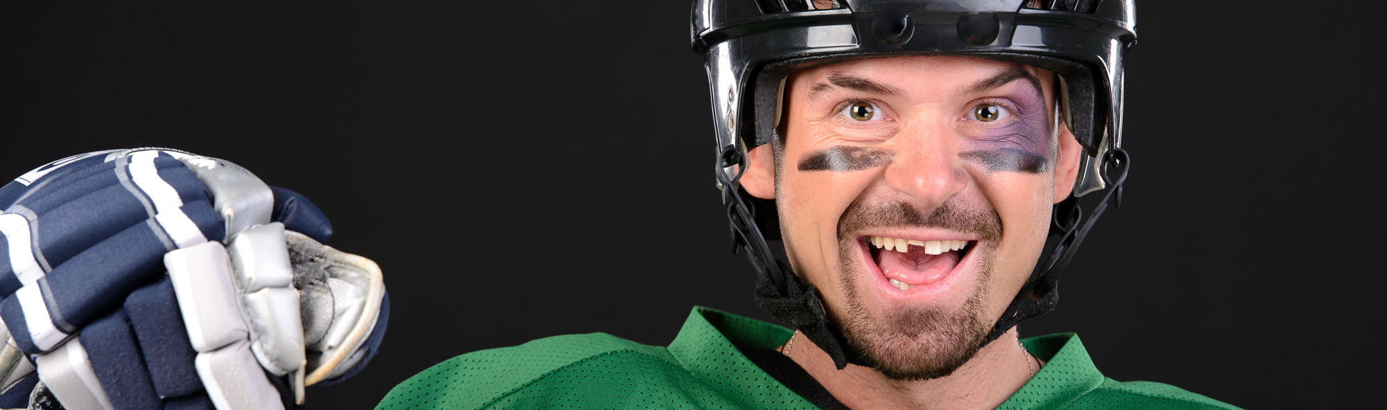 hockey player missing a tooth and smiling