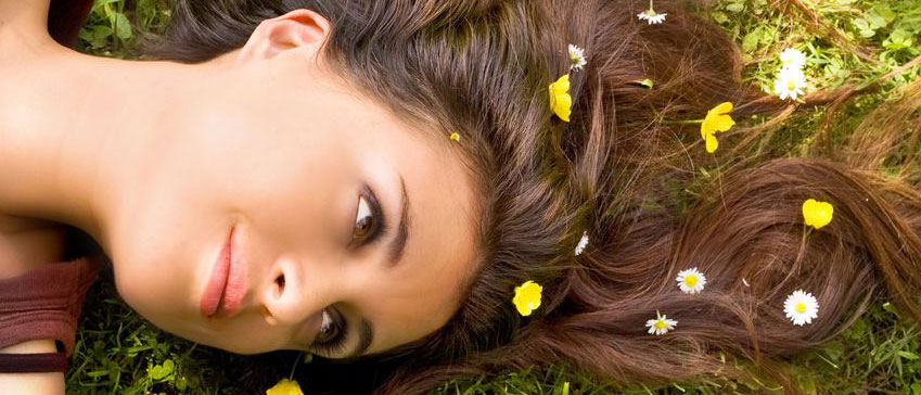 pretty woman laying down with flowers in hair